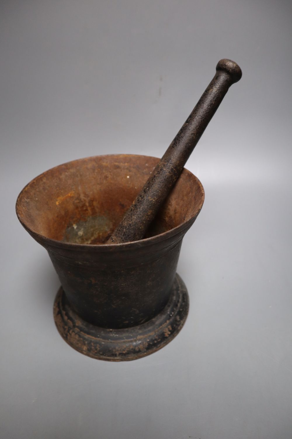 An 18th century iron pestle and mortar, pestle 16cm